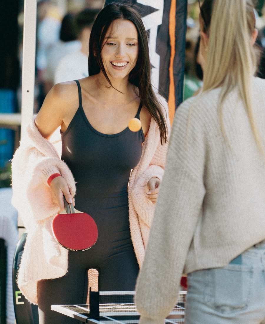 Guests playing table tennis next to the courts